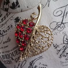 vintage heart shaped leaf brooch with red rhinestones. costume jewelry. pretty gold toned metal. one side is set with deep red rhinestones and the other side is a filigree design. measures 2 inches long, 1 1/2 inches wide. safety c-clasp pin back. in excellent condition. very pretty to wear for Valentine's day, Fall/Autumn jewelry/wedding accessory.  Valentine gift for her.  bridal brooch bouquet, bridal waist sash. Heart Shaped Leaf, Bridal Brooch, Autumn Jewelry, Bridal Brooch Bouquet, Evening Accessories, Bouquet Bridal, Waist Sash, Wedding Accessory, Brooch Bouquet