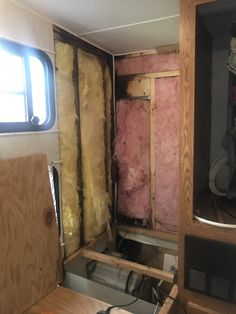 the inside of a house being remodeled with wood framing and insulation in place on the walls