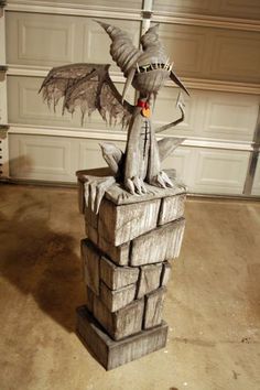 a dragon statue sitting on top of a pile of bricks