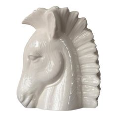 a white ceramic horse head on a white background