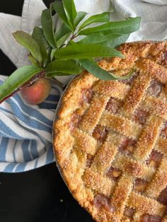 a close up of a pie on a plate near a leafy plant and napkins