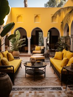 a living room filled with yellow couches and chairs next to a tall palm tree