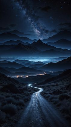 a road going through the middle of a mountain range under a night sky filled with stars