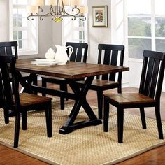 a dining room table with chairs and a rug