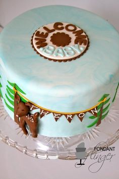 there is a blue cake with white frosting on the top and brown decorations on the bottom