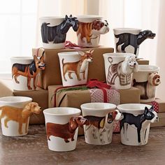 there are many small cups that have dogs on them in different colors and sizes, sitting on top of each other