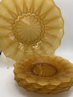 two yellow glass plates sitting next to each other