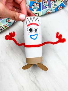 someone is holding up a toilet paper roll with an image of a character on it