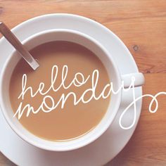 a cup of coffee with the words hello monday written in it