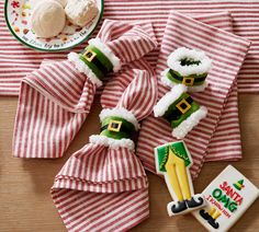 some food is laying out on a table with red and white striped napkins next to it