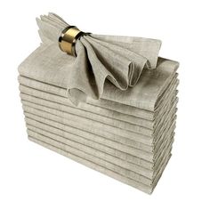 a stack of folded napkins with a gold ring on each end and a bow at the top