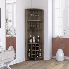 a room with white walls and wood flooring has a wine rack in the corner