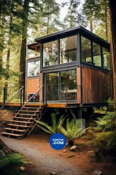 a house in the woods with stairs leading up to it and a blue sign that says moo