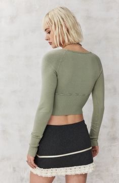 An integrated tie threads its way through a cropped sweater knit with a generous scoop neck and casually cuffed sleeves. 16" length (size Medium) Exclusive retailer Scoop neck Long sleeves Attached waist tie 49% viscose, 32% cotton, 17% polyamide, 2% elastane Dry clean or hand wash, dry flat Imported Fitted Green Cropped Sweater With Long Sleeves, Casual Knit Cropped Sweater, Trendy Crew Neck Crop Top For Fall, Cropped Spring Tops, Trendy Cropped Stretch Cardigan, Fitted Knit Long Sleeve Crop Top, Fitted Long Sleeve Knit Crop Top, Ribbed Long Sleeve Cropped Sweater For Spring, Fitted Knit Crop Top With Long Sleeve