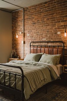 a bed sitting next to a brick wall with two lamps on either side of it