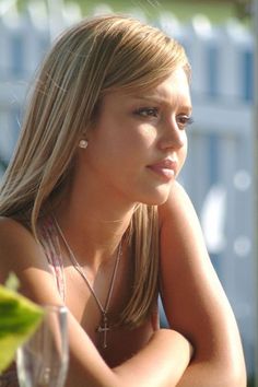 a beautiful young blond woman sitting at a table