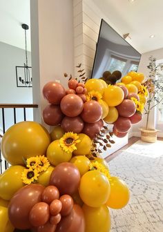 sunflowers and balloons are on display in the foyer