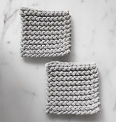 two crocheted dishcloths on a marble surface