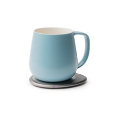 a blue coffee cup sitting on top of a saucer