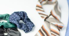 three different types of ties laid out on a white surface with one tied up to the side