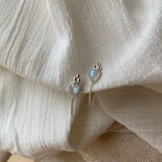 Ophelia Tear Sterling Silvere Rainbow Moonstone Earrings Stunning, gorgeous, and delicate, these beautiful studs can adorn your ears with pear-shaped rainbow moonstone and three beautiful granulation circles at the top, and a gorgeous delicate chain that connects to the backing. These beautiful earrings are perfectly balanced and look great alone, and fabulous paired with hoops (for your second ear piercing). Our jewels are here to make you feel empowered and radiant. * Wrap around studs (never lose your backs!) * High-quality Sterling Silver * Ethically sourced Rainbow Moonstones * Lead & Nickel free * Each moonstone has its own natural sheen so your piece is practically one of a kind! * Also available in 14K Gold Rainbow Moonstone Wildly feminine and overflowing in goddess energy. Our dr Moon Beauty, Second Ear Piercing, Ear Styling, Moon Necklace Silver, Rainbow Moonstone Necklace, Dainty Necklaces, Moonstone Earrings, Moonstone Necklace, June Birthstone