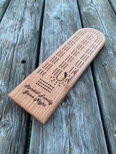 a wooden board with holes in it sitting on a table