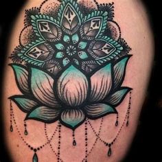 a woman's thigh with a flower tattoo on it