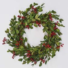 a wreath with red berries and green leaves