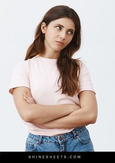 a woman with her arms crossed looking at the camera