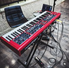 an electronic keyboard sitting on top of a hard wood floor