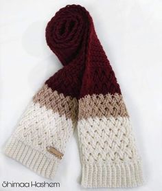 a knitted hat and scarf are sitting on a white surface