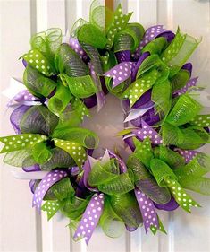 a green wreath with purple and white polka dots