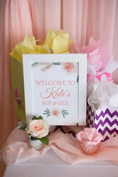 there is a sign that says welcome to kate's sip and see on the table