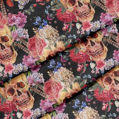 a skull and flowers print on black fabric