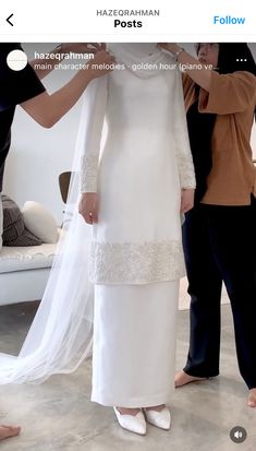 the woman is getting ready to wear her wedding dress