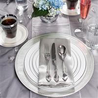 a table set with silverware and flowers