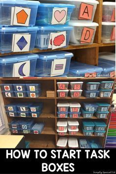 several plastic bins with words and pictures on them in the middle of a classroom