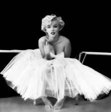 a black and white photo of a woman in a tutu