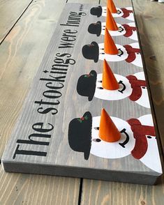 a wooden sign with cones on it that says, the cats are coming to town