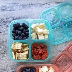 three plastic containers filled with blueberries, cheese and crackers next to each other