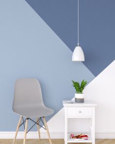 a white chair sitting next to a table with a potted plant on it