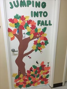 a door decorated with fall leaves and the words jumping into fall