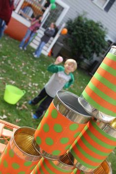 there are many orange and green objects on the table in front of some kids outside