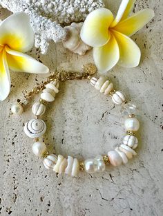 Large freshwater baroque pearl in the centre following through with shells, crystals white howlite stones and a large conch shell, attached with a gold crab claw clasp, extra chain for sizing.  8.5 inches long White Baroque Pearl Jewelry With Natural Stones, White Pearl Bracelet With Charm For Beach, White Bohemian Bracelet With Pearl Charm, White Baroque Pearl Chain Shell Necklace, Bohemian White Bracelets With Pearl Charm, White Bohemian Pearl Bracelet With Pearl Charm, White Baroque Pearl Shell Necklace With Pearl Chain, White Bohemian Pearl Bracelet With Charm, Bohemian White Bracelet With Pearl Charm