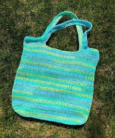 a crocheted bag laying on the grass