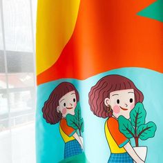 the girl is holding a plant in her hand while standing next to an orange and blue flag