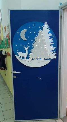 a door decorated with christmas trees and reindeers