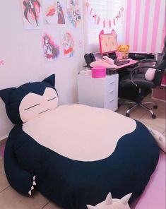 a bedroom with pink and white striped walls, a bed in the shape of a cat