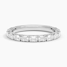 a white gold wedding band with baguetts set in the middle and side stones