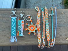 bracelets and keychains are displayed on a wooden bench